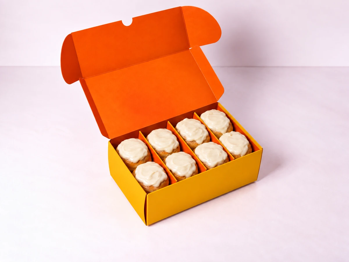 Power 8: eight cream-cheese mini cinnamon rolls in an open yellow Cinnalab box